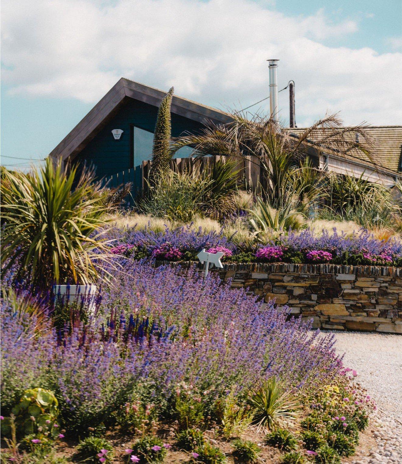 a house with a garden in front of it and a driveway